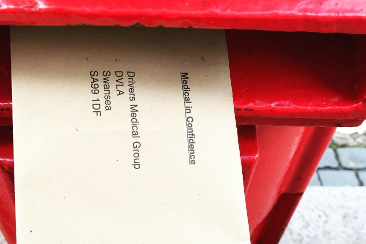 Letter addressed to DVLA going in to a post box
